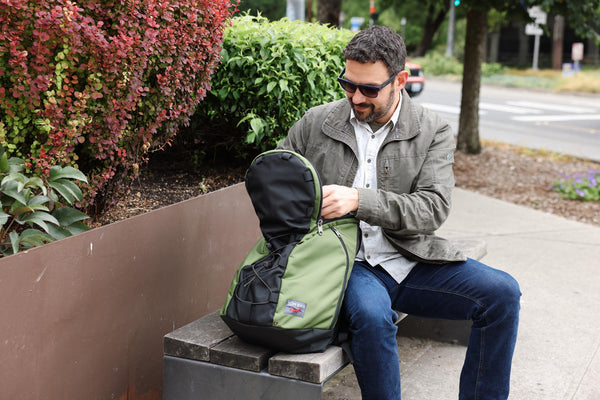 A person accessing the main compartment of a Smart Alec 2.0